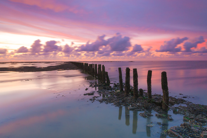 A colorful and dramatic sunset over the Wadden sea near Ternaard