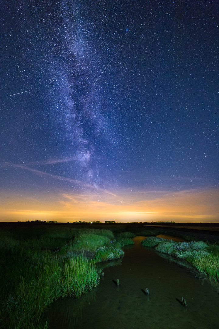 The Milky Way above the Wadden Sea, The Netherlands Had a great time last night trying to capture the Perseids. Canon Eos 6D Mark II with a 14mm f/2.8. Blended in Photoshop from 2 images. One image exposed for the foreground and one for the sky.