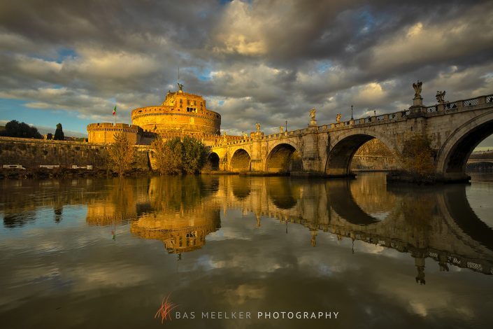 View over the Tiber in Rome with the Ponte Sant'Angelo and Castel Sant'Angelo on a sunny autumn afternoon with warm golden light - Rome, Italy