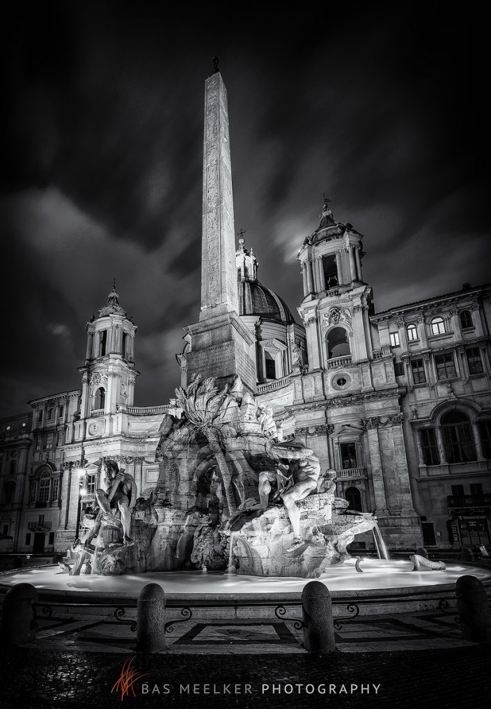 Fountain of the Four Rivers with an Egyptian obelisk and Sant Agnese Church on the famous Piazza Navona Square in the morning, Rome, Italy.