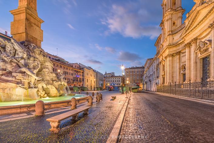 Piazza Navona at dawn with the famous Fontana dei Quattro Fiumi fountain made by Bernini in Rome, Italy