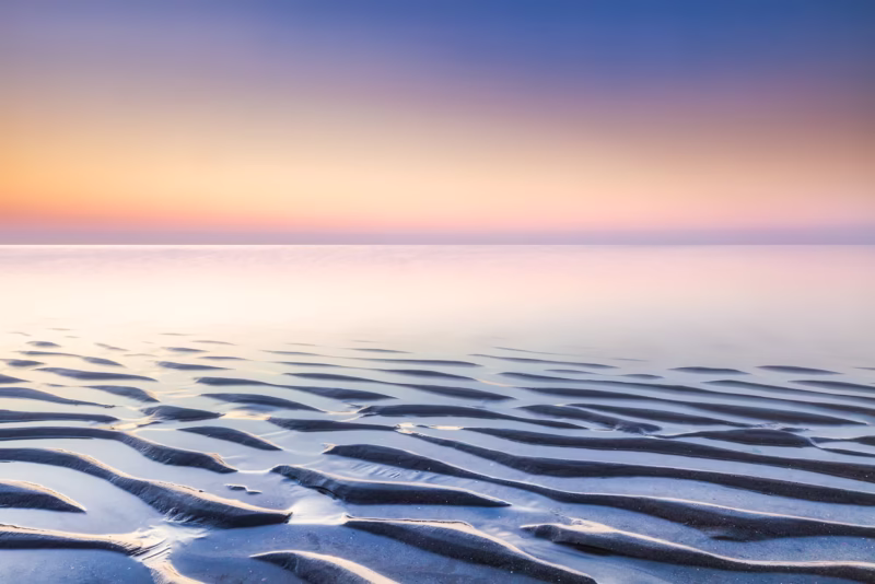 Een serene zonsondergang op het strand van Hargen aan Zee