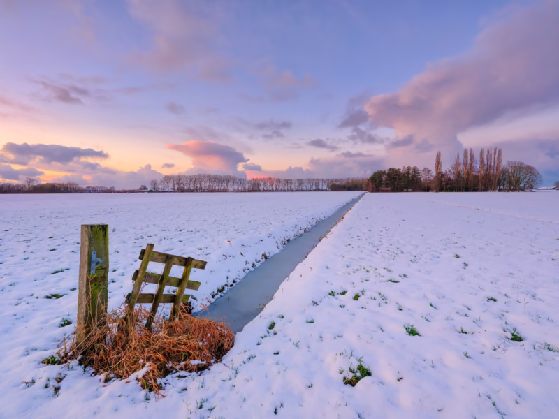 Zonsondergang over een winterlandschap bij Noordeloos, Nederland